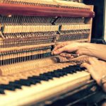 Man tuning piano in Seattle