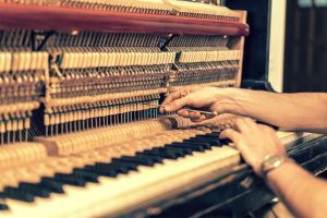 Man tuning piano in Seattle